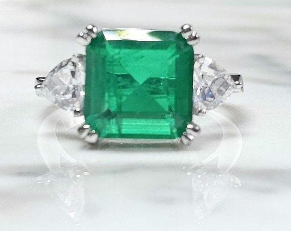 5ct Green stone and two trillion 0.50 ct cz stone ring